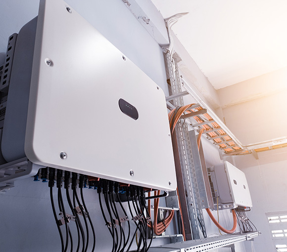 solar inverters mounted on a wall with multiple cables showcasing renewable energy technology for homes and businesses with eight connections for optimal performance